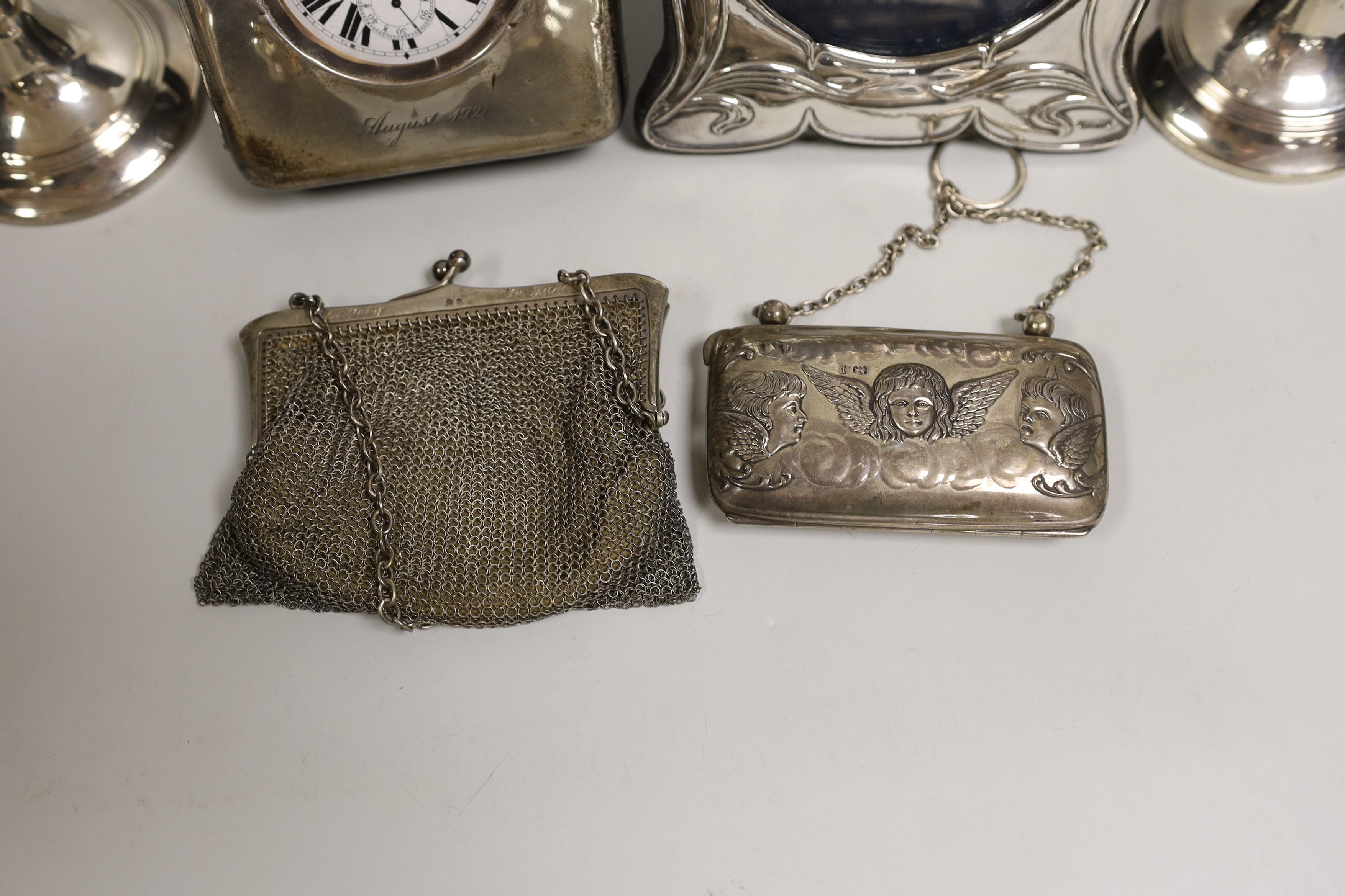 Mixed silver including a pair of George V mounted candlesticks, London, 1919, 17.4cm, travelling pocket watch case, purse, mesh bag and a modern photograph frame.